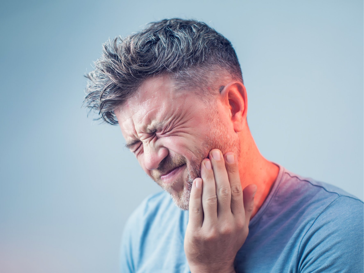 Man experiencing severe tooth pain, indicating a dental emergency