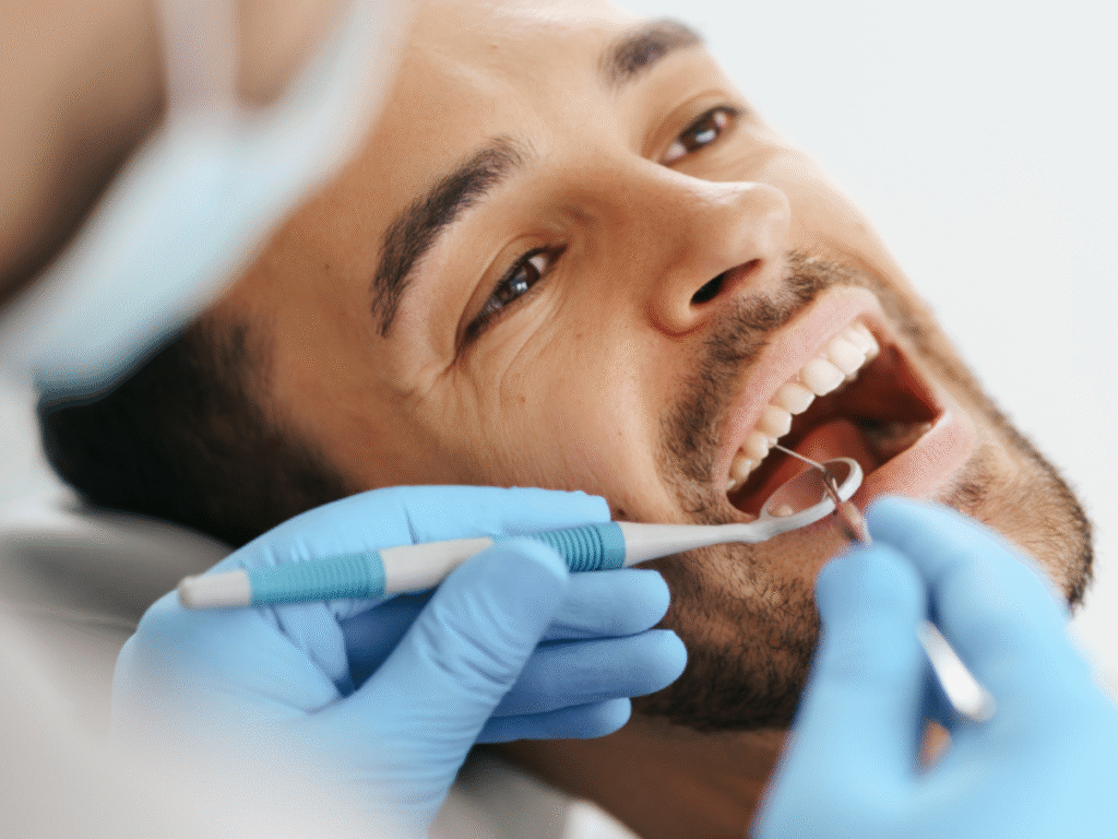 Dentist examining a patient’s teeth during a routine dental check-up