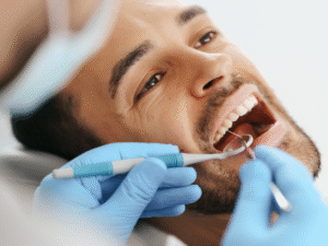 Dentist examining a patient’s teeth during a routine dental check-up