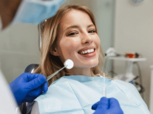 Smiling woman sitting in a dental chair during an implant consultation, showing comfort and confidence in modern dental care.