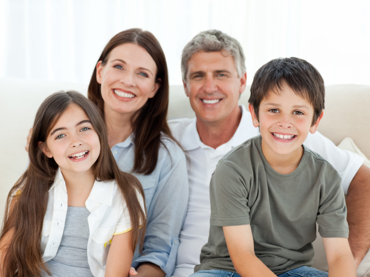 Happy family smiling together, representing complete family dental care services.