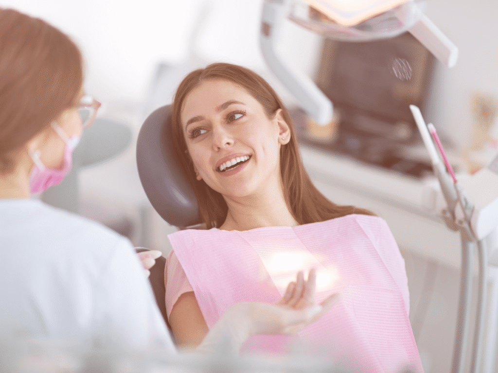 Patient smiling while speaking with a dentist during a routine dental checkup
