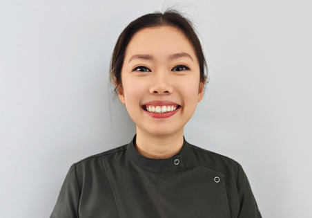 Dr. Careena Tan smiling in a professional headshot wearing dental clinic attire.