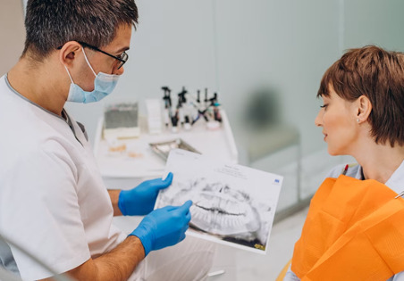 Dentist explaining preventive dentistry tips to a patient at Bay of Isles Dental Clinic