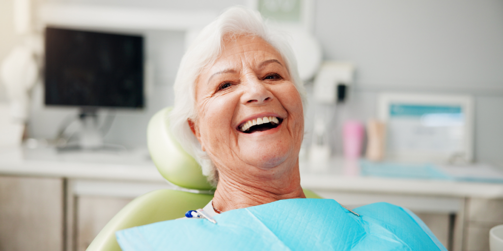 Patient smiling after all on 4 dental implants treatment at Bay of Isles Dental