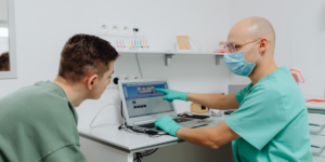 Dentist explaining all on 4 dental implants esperance treatment plan to patient