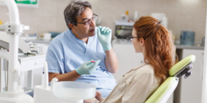 dentist explaining dental treatment to patient in clinic chair