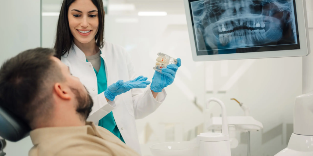 dentist explaining dental x ray and treatment plan to patient