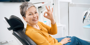 smiling patient in dental chair showing positive dental experience